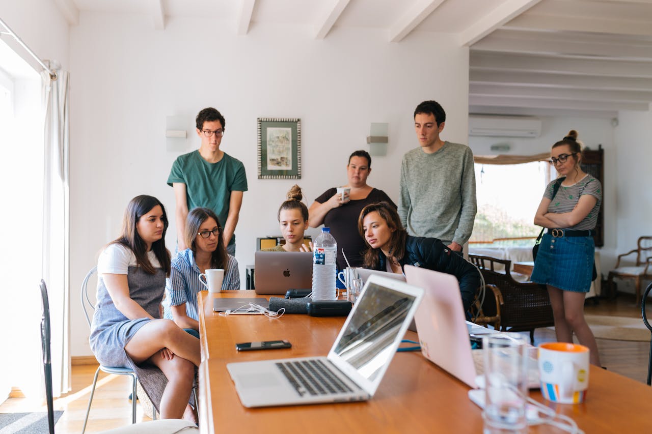 services-cta Group of young professionals engaged in a collaborative meeting in a modern office setting.